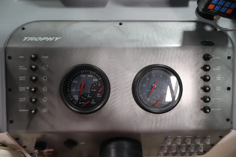 Slide: The Image of Control panel of a 2004 Trophy 2002 Walkaround boat with gauges and switches. - 25