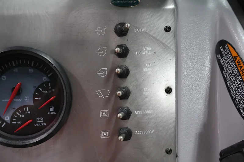 Slide: The Image of Dashboard of a 2004 Trophy 2002 Walkaround boat with switches and gauges. - 27