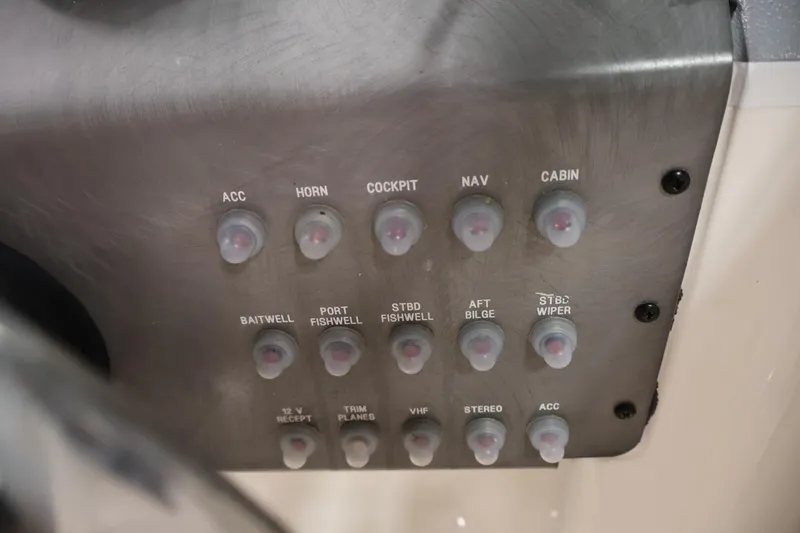 Slide: The Image of Control panel of a 2004 Trophy 2002 Walkaround boat with labeled switches. - 28