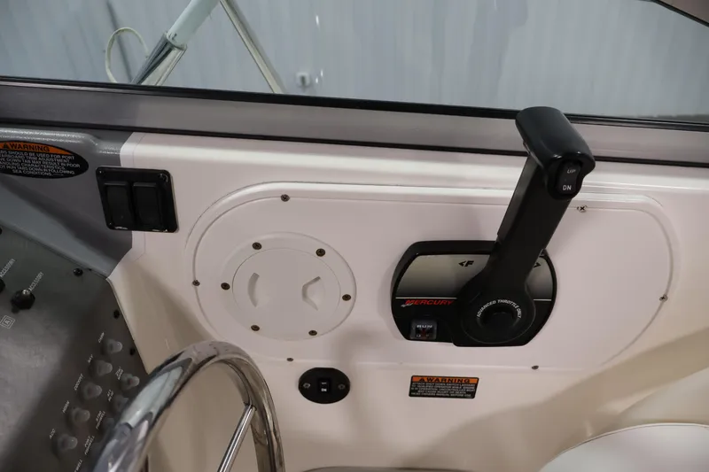 Slide: The Image of 2004 Trophy 2002 Walkaround boat control panel with Mercury throttle lever. - 30