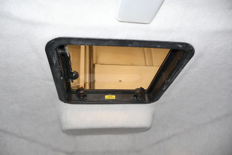 Slide: The Image of Hatch window inside 2004 Trophy 2002 Walkaround boat, featuring secure locking mechanism. - 35