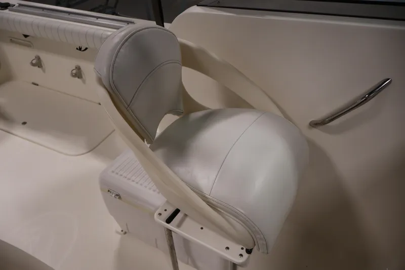 Slide: The Image of 2004 Trophy 2002 Walkaround boat interior with white seating and handle. - 36