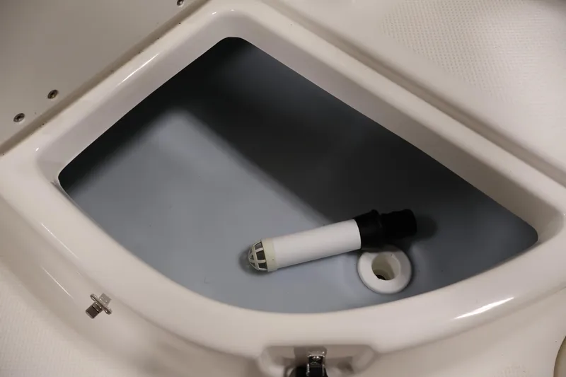Slide: The Image of Storage compartment in a 2004 Trophy 2002 Walkaround boat, featuring a drain plug. - 39