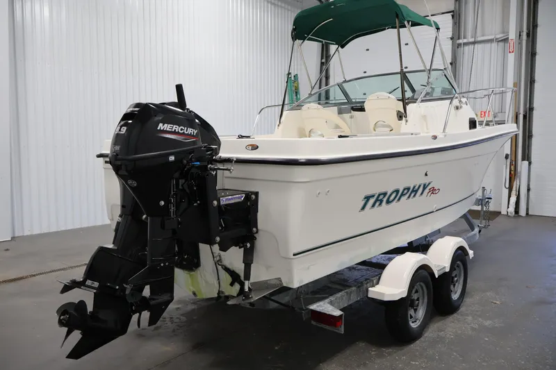 Slide: The Image of 2004 Trophy 2002 Walkaround boat with Mercury engine on trailer in indoor setting. - 4