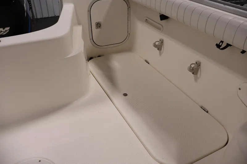 Slide: The Image of 2004 Trophy 2002 Walkaround boat interior, featuring storage compartment and seating area. - 43