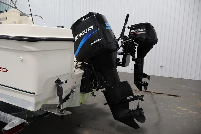 Slide: The Image of 2004 Trophy 2002 Walkaround boat with dual Mercury outboard engines in a garage. - 47