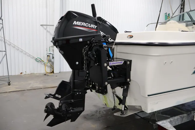 Slide: The Image of 2004 Trophy 2002 Walkaround boat with Mercury outboard motor in a garage setting. - 51