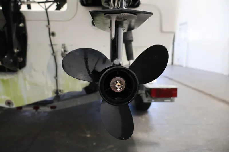 Slide: The Image of Close-up of a 2004 Trophy 2002 Walkaround boat propeller in a garage setting. - 53