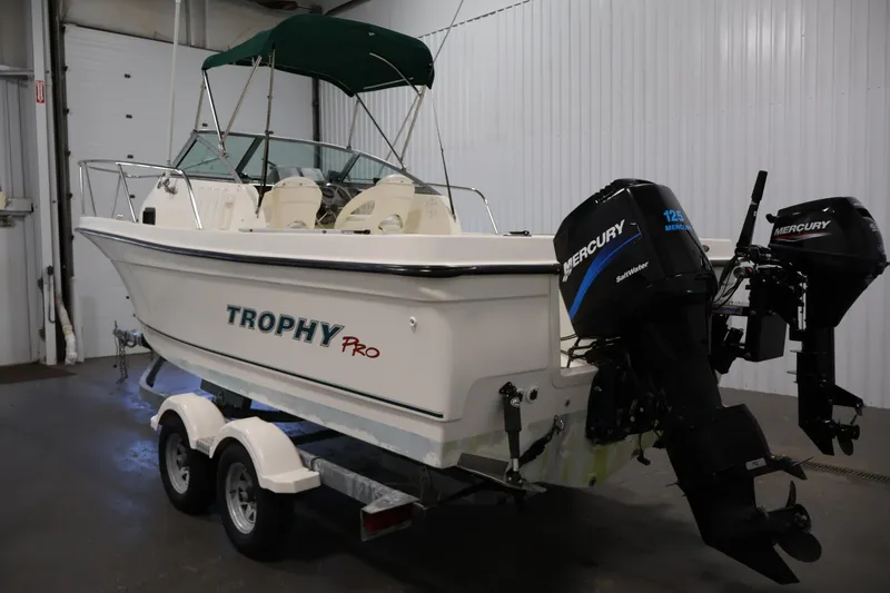 Slide: The Image of 2004 Trophy 2002 Walkaround boat with dual Mercury outboard engines on a trailer. - 6
