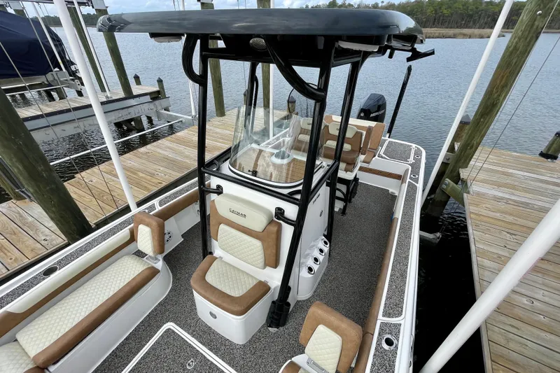 Slide: The Image of 2021 Caymas 26 HB boat docked, featuring spacious seating and modern design. - 13