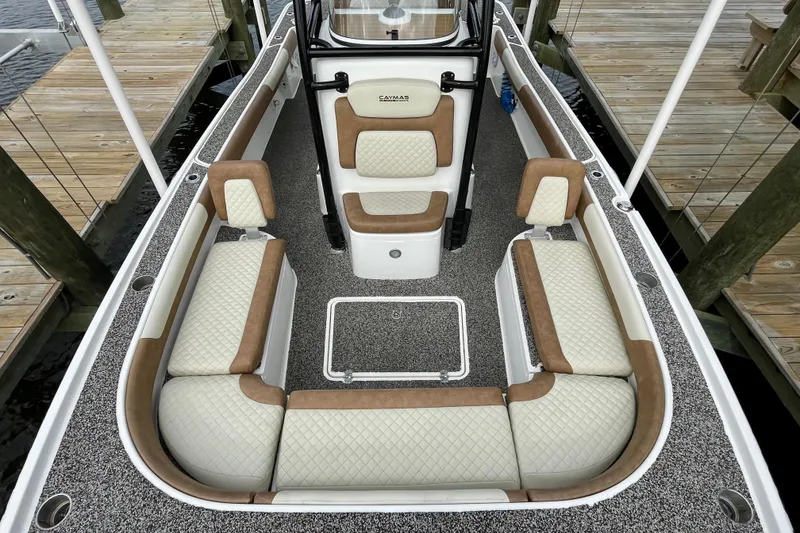 Slide: The Image of 2021 Caymas 26 HB boat interior with cushioned seating and textured flooring. - 14