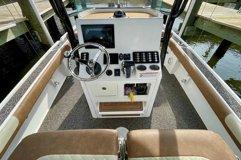 Slide: The Image of 2021 Caymas 26 HB boat console with steering wheel and control panel. - 19
