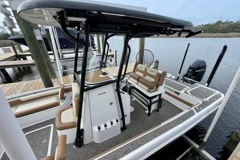 Slide: The Image of 2021 Caymas 26 HB boat docked, featuring sleek design and comfortable seating. - 3