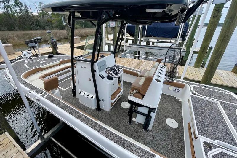 Slide: The Image of 2021 Caymas 26 HB boat with modern console and seating at a dock. - 4