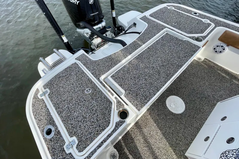 Slide: The Image of 2021 Caymas 26 HB boat deck with textured flooring and Mercury Verado engine. - 7