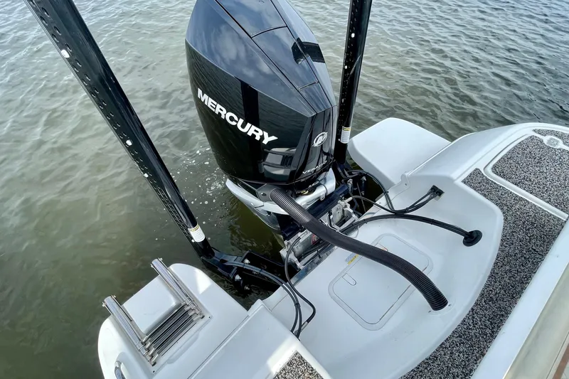 Slide: The Image of 2021 Caymas 26 HB boat with Mercury engine on water. - 9