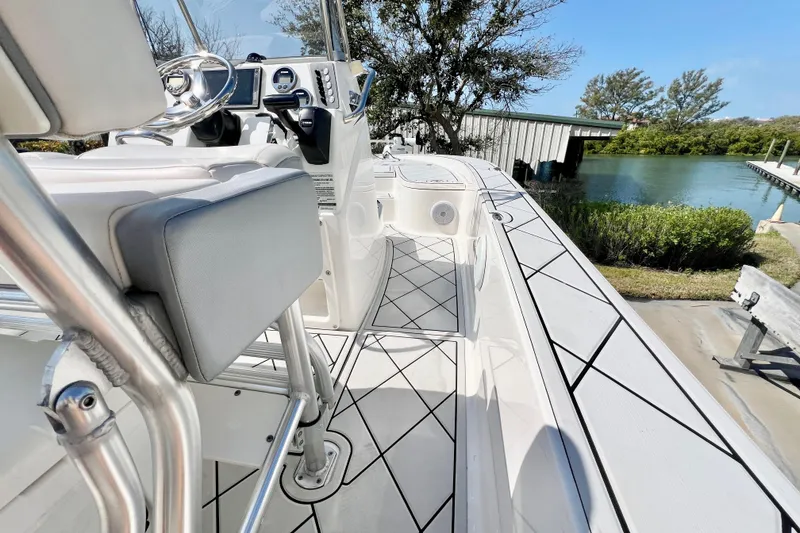 Slide: The Image of 2019 Robalo 206 Cayman boat interior with sleek design and modern controls by the water. - 12