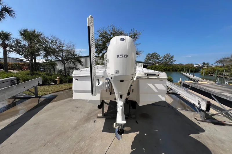 Slide: The Image of 2019 Robalo 206 Cayman boat with Yamaha 150 engine, docked near a scenic waterfront. - 5