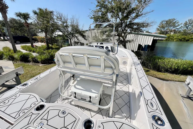 Slide: The Image of 2019 Robalo 206 Cayman boat with sleek design, docked near lush greenery and calm water. - 9