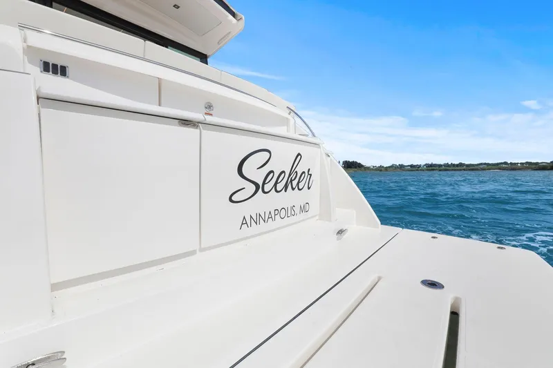 Slide: The Image of 2023 Tiara Yachts C49 Coupe named "Seeker" in Annapolis, MD, on the water. - 12