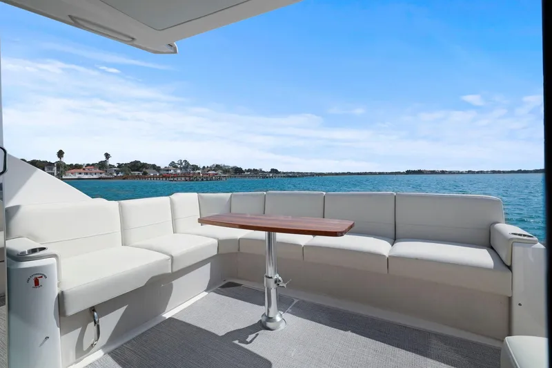 Slide: The Image of 2023 Tiara Yachts C49 Coupe deck with seating and ocean view. - 20