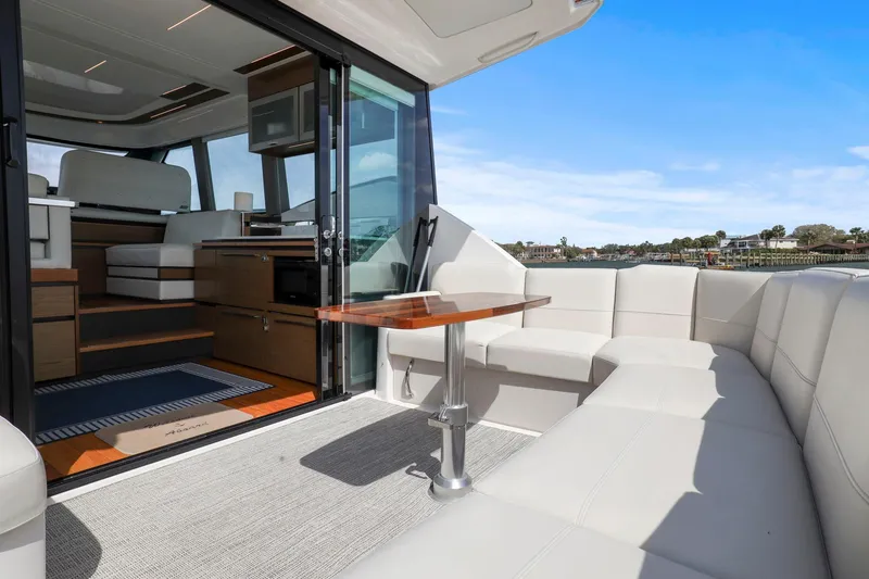 Slide: The Image of 2023 Tiara Yachts C49 Coupe interior with luxurious seating and modern design. - 23