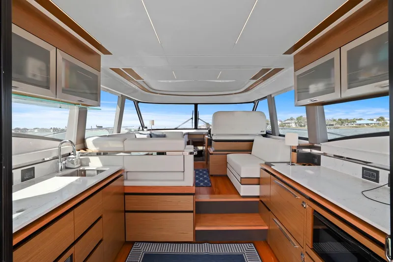 Slide: The Image of Luxurious interior of 2023 Tiara Yachts C49 Coupe with modern kitchen and seating area. - 28