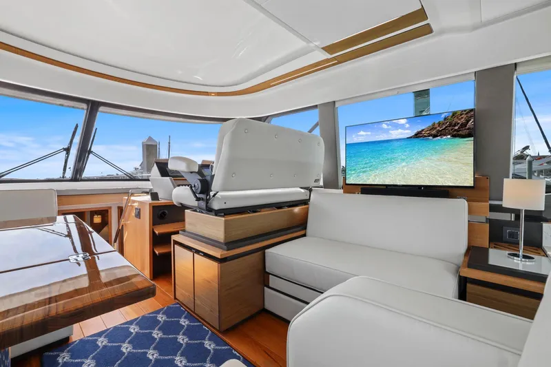 Slide: The Image of Luxurious interior of 2023 Tiara Yachts C49 Coupe with elegant seating and ocean view on TV. - 42