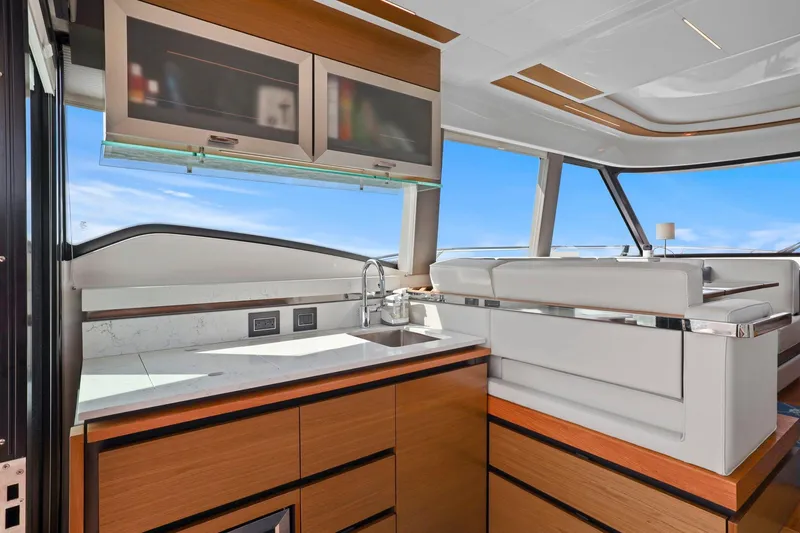 Slide: The Image of Luxurious interior of 2023 Tiara Yachts C49 Coupe with modern kitchen and seating area. - 45