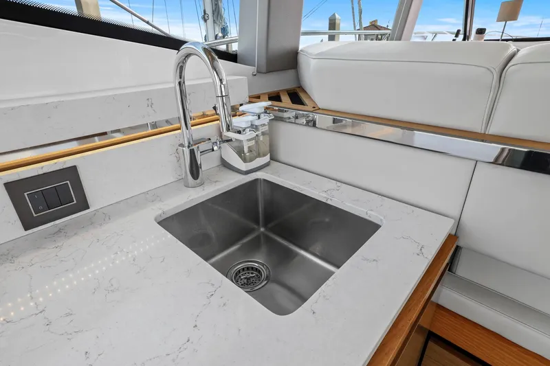 Slide: The Image of Modern kitchen sink in 2023 Tiara Yachts C49 Coupe, featuring sleek design and marble countertop. - 47