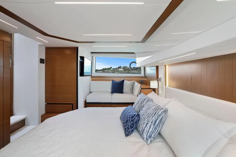 Slide: The Image of Luxurious interior of 2023 Tiara Yachts C49 Coupe with elegant bedding and scenic window view. - 53