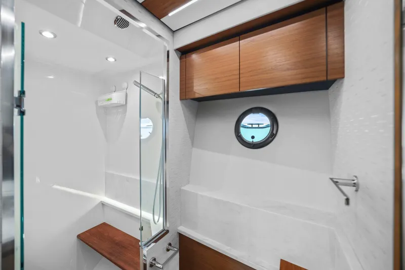 Slide: The Image of Luxurious bathroom in 2023 Tiara Yachts C49 Coupe with modern fixtures and wood accents. - 59