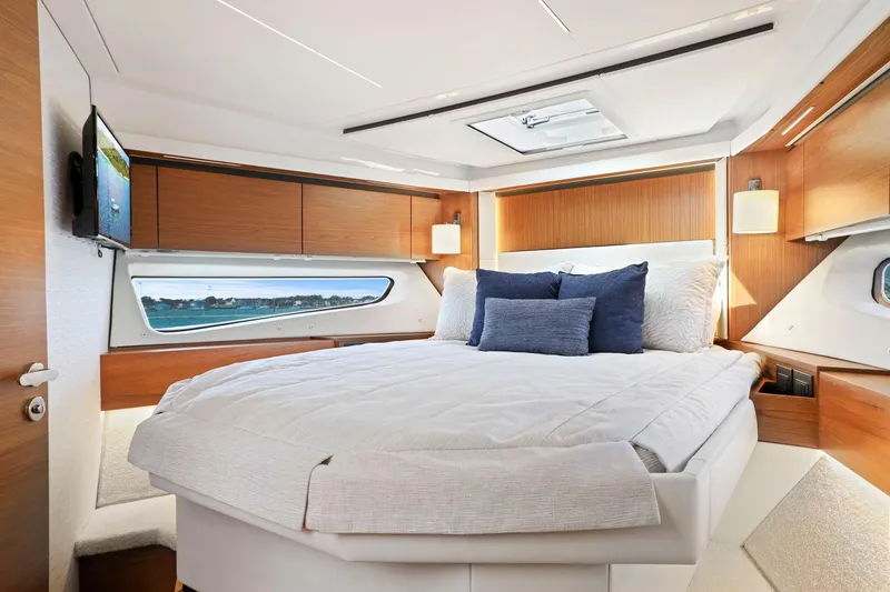 Slide: The Image of Luxurious bedroom interior of 2023 Tiara Yachts C49 Coupe with modern design and natural light. - 64