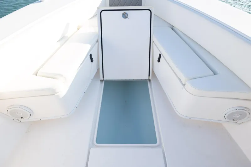 Slide: The Image of Interior view of a 2013 Contender 32 Tournament boat with white seating and storage. - 12