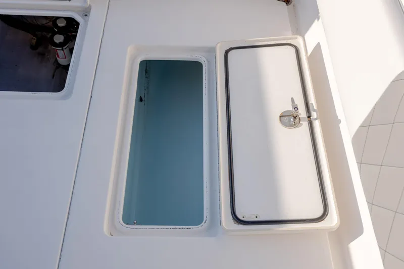 Slide: The Image of 2013 Contender 32 Tournament boat storage compartments with open and closed hatches. - 13
