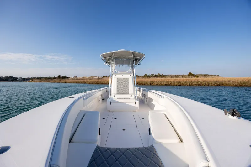 Slide: The Image of 2013 Contender 32 Tournament boat on calm water, clear sky background. - 15
