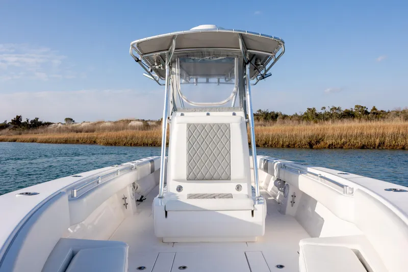 Slide: The Image of 2013 Contender 32 Tournament boat on calm water, featuring sleek design and spacious deck. - 16