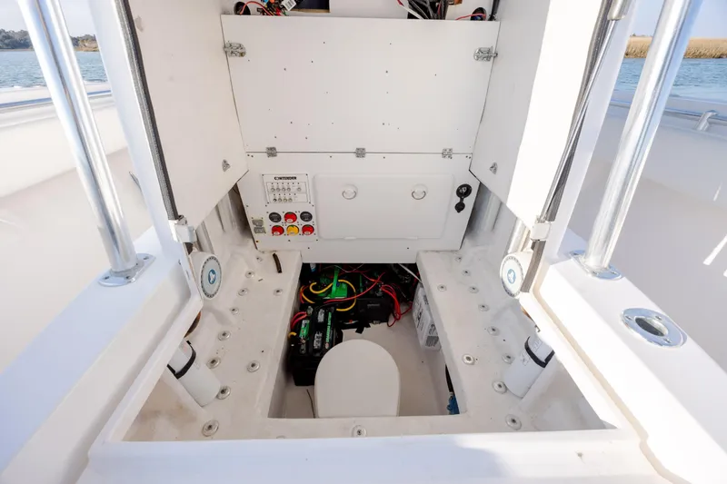 Slide: The Image of 2013 Contender 32 Tournament boat interior showing electrical panel and storage area. - 18