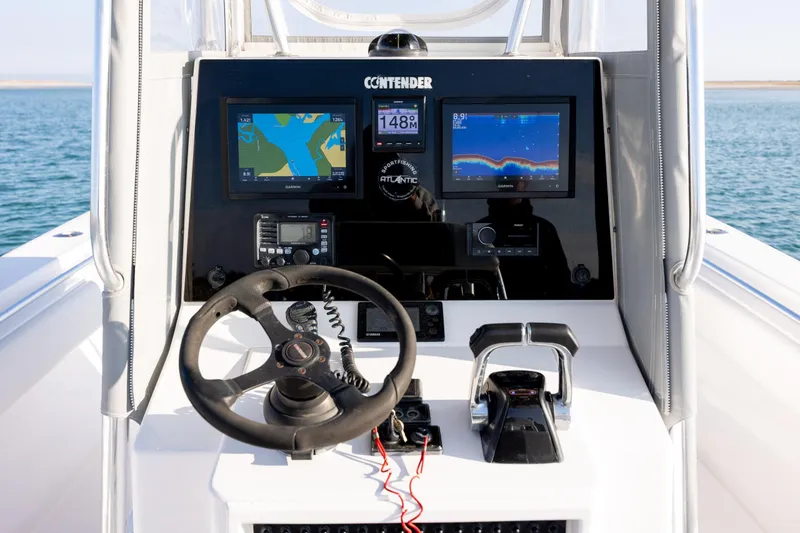 Slide: The Image of 2013 Contender 32 Tournament boat dashboard with navigation and control systems. - 21