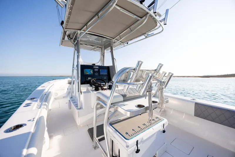 Slide: The Image of 2013 Contender 32 Tournament boat interior with helm, rod holders, and ocean view. - 22