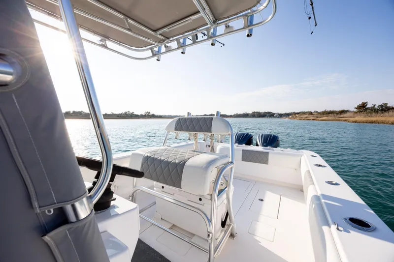 Slide: The Image of 2013 Contender 32 Tournament boat on calm water, featuring sleek seating and modern design. - 23