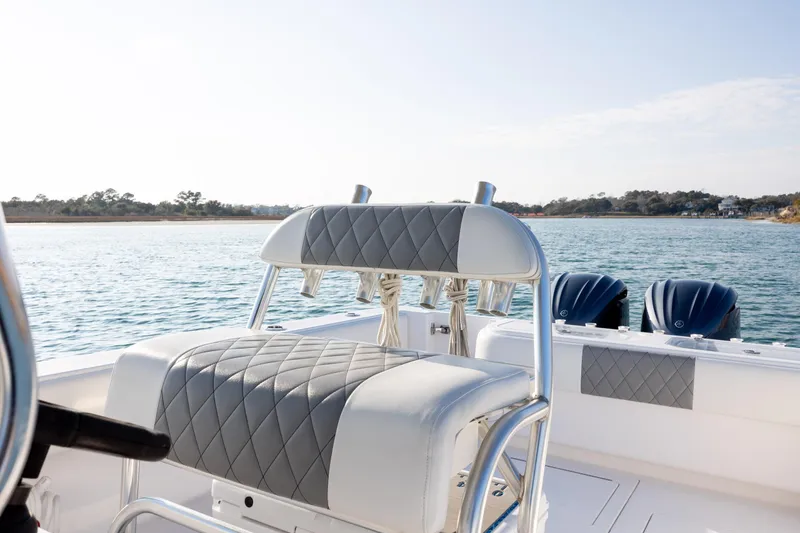 Slide: The Image of 2013 Contender 32 Tournament boat with cushioned seating, dual engines, and scenic water view. - 24