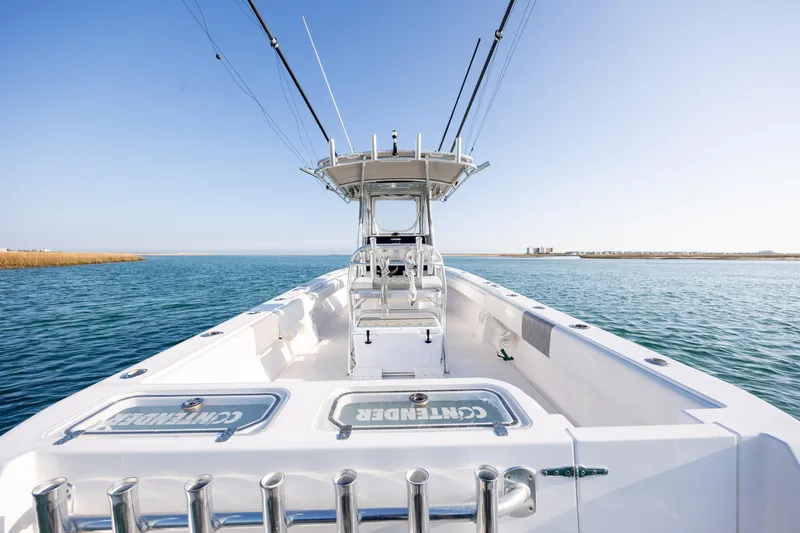 Slide: The Image of 2013 Contender 32 Tournament boat on open water, clear sky, fishing rods visible. - 27