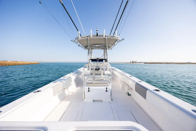 Slide: The Image of 2013 Contender 32 Tournament boat on open water, clear sky, spacious deck. - 28