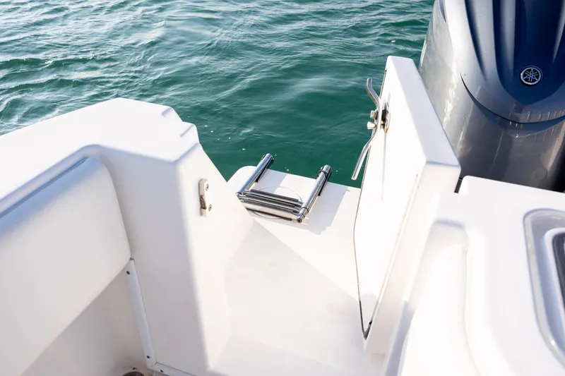 Slide: The Image of Contender 32 Tournament 2013 boat with swim ladder and open hatch near water. - 30