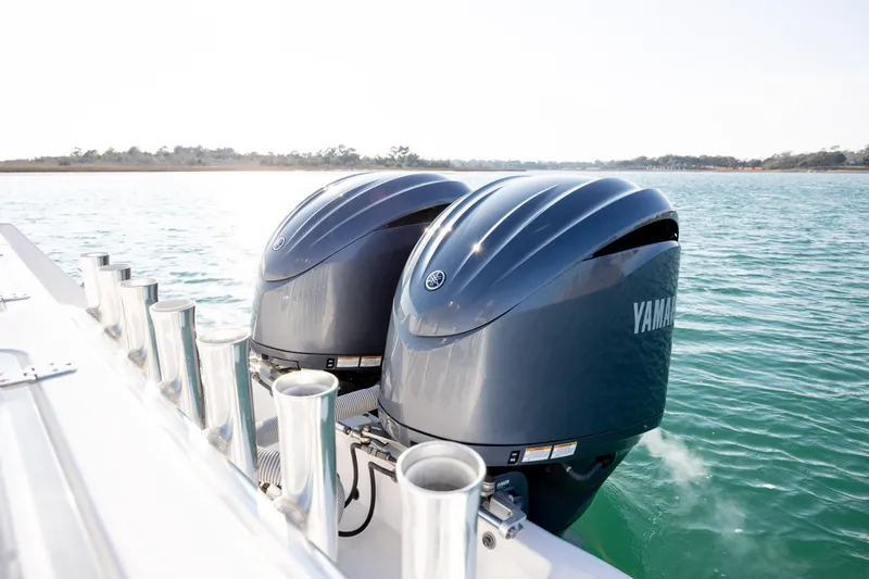 Slide: The Image of Twin Yamaha outboard engines on a 2013 Contender 32 Tournament boat in open water. - 31