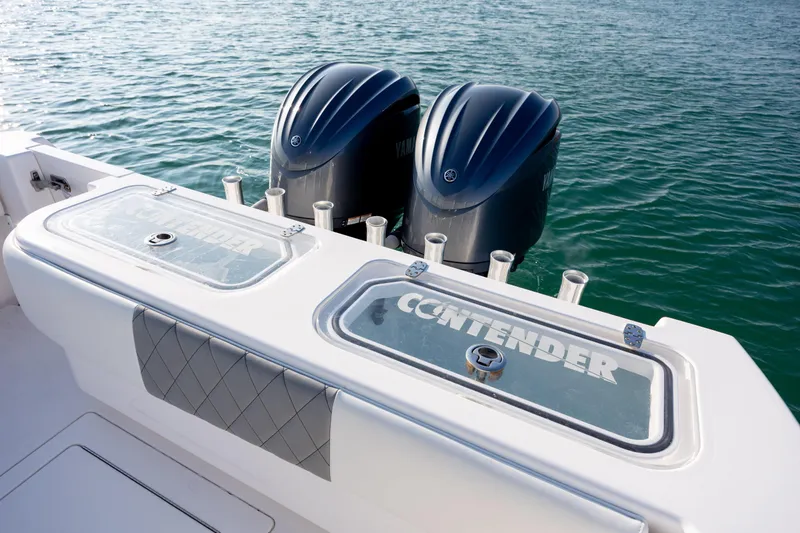 Slide: The Image of 2013 Contender 32 Tournament boat with dual Yamaha engines on the water. - 33