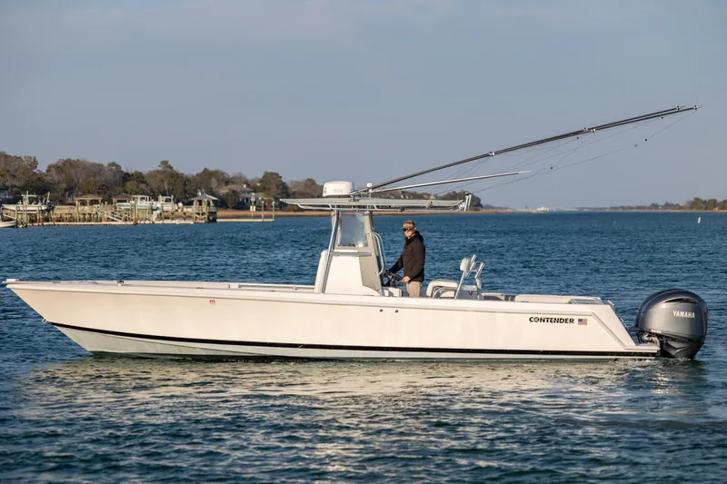 Slide: The Image of 2013 Contender 32 Tournament boat on water with Yamaha engine, side view. - 4