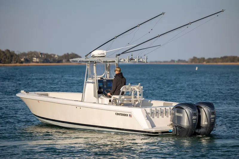 Slide: The Image of 2013 Contender 32 Tournament boat with dual Yamaha engines on open water. - 5