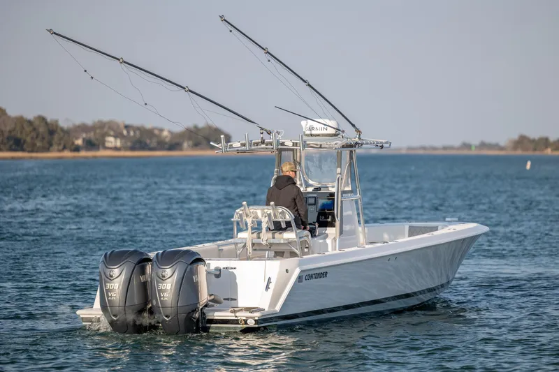 Slide: The Image of 2013 Contender 32 Tournament boat with dual Yamaha engines on open water. - 7